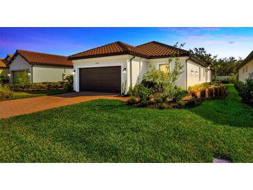 Beautiful single-Gathering home showcasing a well-manicured lawn and a two-car garage at 4576 Garofalo Rd, Wesley Chapel, FL 33543