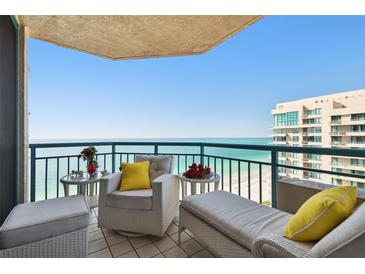 Relax on this tiled balcony with views of the ocean and comfortable outdoor furniture at 1540 Gulf Blvd # 1705, Clearwater, FL 33767