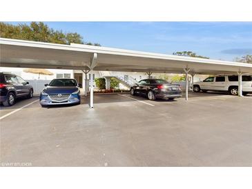 View of the covered carport parking area with multiple vehicles parked in designated spaces at 1655 S Highland Ave # D238, Clearwater, FL 33756