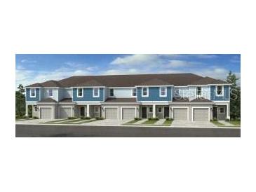 Modern townhouses with attached garages and neutral color scheme at 2073 Hallier Cv, Wesley Chapel, FL 33543