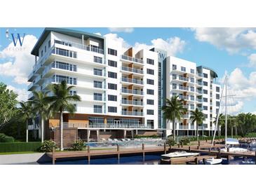 Modern white building with balconies, pool, boardwalk, and boat dock providing a luxurious waterfront experience at 411 E Shore Dr # 308, Clearwater Beach, FL 33767