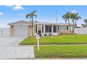 Single-story house with a well-maintained lawn and attached garage at 5152 Victoria Ln, Holiday, FL 34690