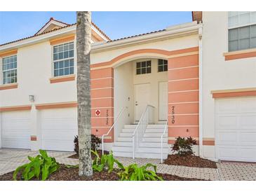 Inviting condo exterior with peach accents, white trim, and manicured landscaping at 7532 Marsh Orchid Cir # 8-201, Bradenton, FL 34203