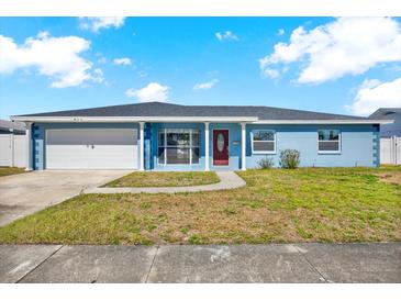 Charming single-story home featuring an attached garage and a well-maintained front yard in a suburban setting at 8421 Flagstone Dr, Tampa, FL 33615