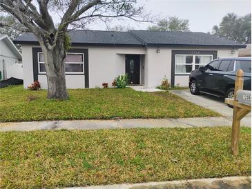 Charming single-story home featuring a well-maintained lawn and classic architectural details at 12368 70Th St, Largo, FL 33773