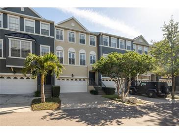 Charming townhome with well-maintained landscaping, two car garage and inviting curb appeal at 1442 Harbour Walk Rd, Tampa, FL 33602