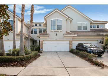 Charming townhome showcasing a beautifully landscaped front yard and two car garage at 14543 Mirabelle Vista Cir, Tampa, FL 33626