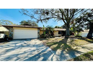 Charming single-story home with a well-manicured front yard and a two-car garage at 1670 Monterey Dr, Clearwater, FL 33756