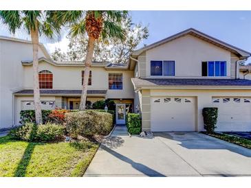 Charming townhome featuring an attached garage, well-maintained landscaping, and a welcoming entrance at 2559 Stony Brook Ln, Clearwater, FL 33761