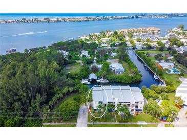 Beautiful waterfront property featuring a three-story building with lush landscaping and boating access to the open bay at 4212 126Th W St # 401, Cortez, FL 34215
