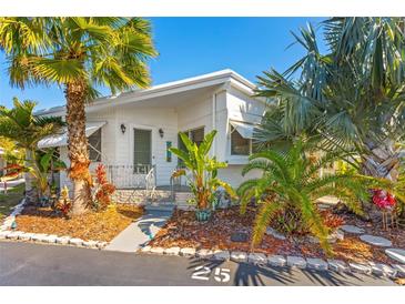 Charming single-story home with well maintained exterior, lush landscaping, and a welcoming front porch at 4851 W Gandy Blvd # B2L25, Tampa, FL 33611