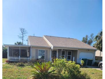Charming single story home with a screened in porch, attached garage and a well maintained front lawn at 18231 Steele Ave, Port Charlotte, FL 33948
