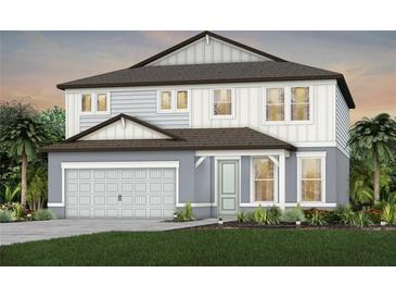 Two-story home featuring a neutral color palette, two car garage, and a well manicured lawn at 36424 Sespe Creek Ct, Zephyrhills, FL 33540