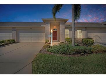 Charming exterior view of a well-maintained home with a two-car garage and landscaped front yard at 12141 Arron Ter, Trinity, FL 34655