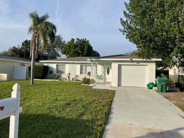 Charming single-story home with a well-maintained lawn and a spacious two-car garage at 6483 43Rd N Ave, Kenneth City, FL 33709