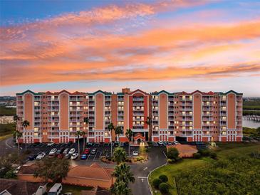 A condo complex with colorful sunrise sky, well maintained landscaping, and ample parking at 4516 Seagull Dr # 303, New Port Richey, FL 34652