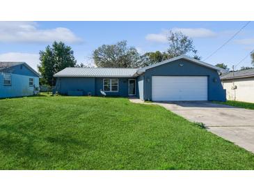 Ranch style home with a metal roof and a spacious yard at 7353 Knoll Dr, New Port Richey, FL 34653