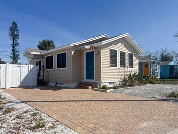 Charming home featuring a brick driveway, mature landscaping, and inviting curb appeal at 13331 1St E St, Madeira Beach, FL 33708