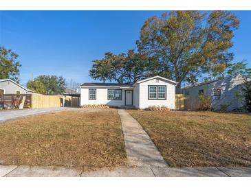 Charming single-story home with a well-manicured lawn and a quaint walkway leading to the front door at 167 83Rd N Ave, St Petersburg, FL 33702