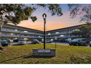 Brittany Farm House complex with manicured lawn, lamp post, and ample parking at 2441 Persian Dr # 53, Clearwater, FL 33763