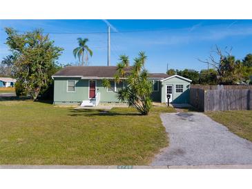 Charming single-story home features a well-maintained lawn and inviting curb appeal under a clear blue sky at 2749 16Th N Ave, St Petersburg, FL 33713