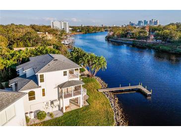 Stunning waterfront home with private dock access and balconies overlooking the tranquil river at 2902 N Shoreview Pl, Tampa, FL 33602