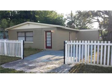 Charming single-story home with a well-maintained lawn and a classic white picket fence at 4208 N 31St St, Tampa, FL 33610