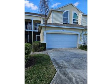 Charming townhome showcasing an attached garage and well-maintained landscaping at 1050 Starkey Rd # 2503, Largo, FL 33771