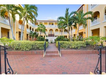 Beautiful courtyard with palm trees, lush landscaping, and attractive architectural details in a Florida community at 210 22Nd Ne Ave # 14, St Petersburg, FL 33704