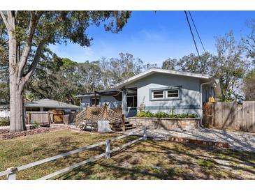 Charming single-story home with a beautifully landscaped front yard and inviting outdoor seating area at 3087 Duane Ave, Oldsmar, FL 34677