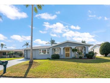 Charming single-story home featuring a well-manicured lawn and inviting front entrance at 3832 Star Island Dr, Holiday, FL 34691