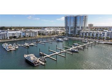 Aerial view of a marina with many boats and a high rise building in the background at 5120 Marina Way # 14002, Tampa, FL 33611