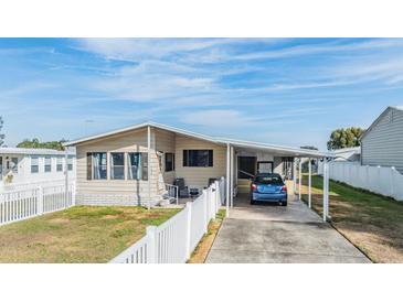 Single-wide manufactured home with carport and fenced yard at 5330 Dean Dairy Rd, Zephyrhills, FL 33541