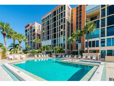 Resort-style pool and spa with surrounding lounge chairs at 7400 Sun Island S Dr # 207, South Pasadena, FL 33707