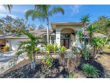 Attractive home with a landscaped yard and a welcoming front porch at 905 Linn Harbor Ct, Tarpon Springs, FL 34689