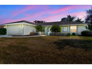 Charming single-story home with well-maintained landscaping, mature trees, and attached two car garage at 10340 Ventura Dr, Spring Hill, FL 34608