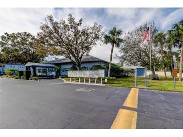 Charming condo complex featuring mature trees, lush landscaping and a convenient mail station at 10800 Us Highway 19 N # 108, Pinellas Park, FL 33782
