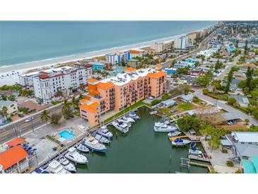 Stunning aerial view of the building, beach, and marina, showcasing the desirable coastal location at 13235 Gulf Blvd # 306, Madeira Beach, FL 33708
