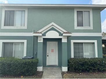 Two-story townhome with light green exterior and landscaping at 1621 Fluorshire Dr, Brandon, FL 33511