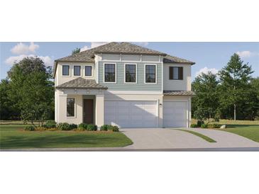 Two-story home with light teal and white siding, two-car garage, and landscaped lawn at 18422 Serene Lake Loop, Lutz, FL 33548