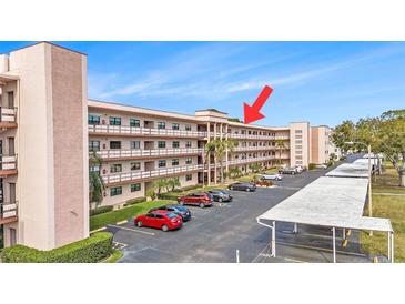 Multi-story condo building with balconies and ample parking at 5980 80Th N St # 410, St Petersburg, FL 33709