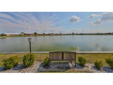 A serene lake view featuring a bench, perfect for enjoying peaceful moments in a tranquil outdoor setting at 1509 Blackstone Cir, Sun City Center, FL 33573