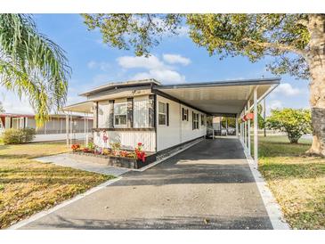 Charming single-story home boasts a covered carport and well-maintained landscaping at 37321 8Th Ave, Zephyrhills, FL 33542
