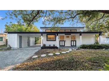 Charming one story house with a carport, black and white trim, and front yard landscaping at 6326 22Nd N Ave, St Petersburg, FL 33710