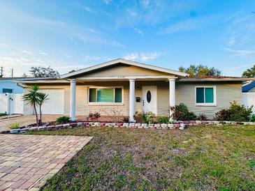 Charming single-story home with well-maintained landscaping, driveway, and inviting front porch at 8139 38Th N Ave, St Petersburg, FL 33710