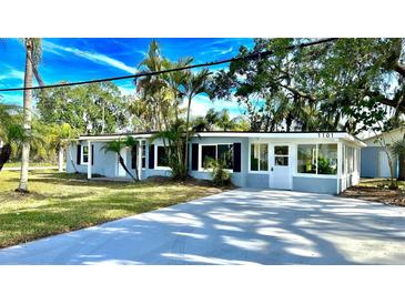 Charming single-story home with manicured lawn, lush landscaping, and a freshly painted driveway at 1101 Canal St, Ruskin, FL 33570