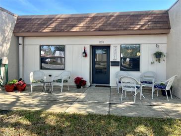 Charming front porch with seating area, perfect for enjoying the outdoors at 1353 Mission Cir, Clearwater, FL 33759