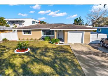 Charming single-story home features a well-manicured lawn and attached one car garage at 1721 S Jefferson Ave, Clearwater, FL 33756