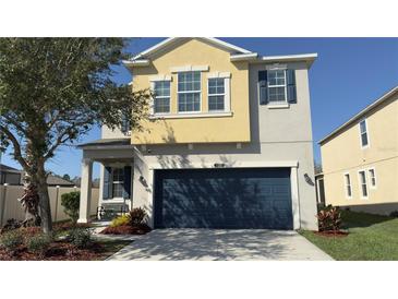 Charming two-story home featuring a spacious two-car garage and colorful landscaping at 21211 Southern Charm Dr, Land O Lakes, FL 34637