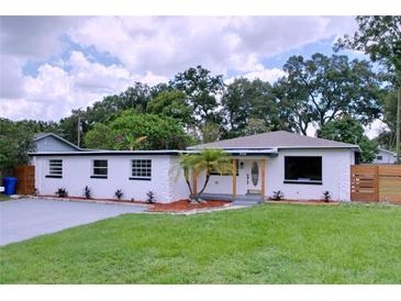 Charming home with a well-manicured lawn, new paint, and refreshed landscaping at 2522 W North St, Tampa, FL 33614